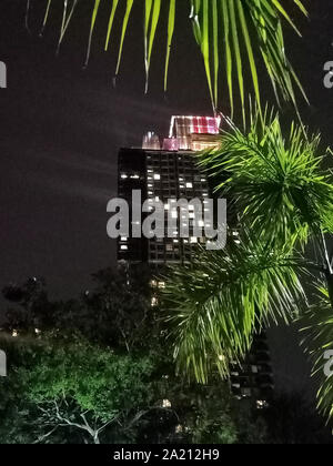 The corner of a tall building at night Stock Photo