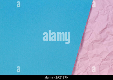 Light blue blank paper sheet over pastel pink crumpled wrinkled paper texture background Stock Photo