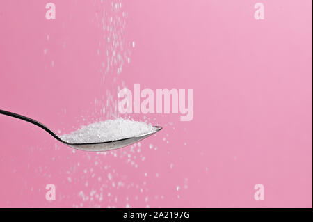 White Sugar Pouring From A Spoon Stock Photo