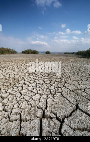 Dry lake bed with natural texture of cracked clay in perspective floor. Death Valley field . background. Selective focus on black soil dark land. Idea Stock Photo