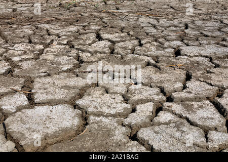 Dry lake bed with natural texture of cracked clay in perspective floor. Death Valley field . background. Selective focus on black soil dark land. Idea Stock Photo