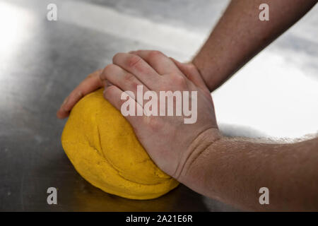 Kneading pasta dough ready to be rolled Stock Photo