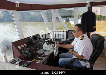 Captain of the Danube River Cruise Ship driving inside the cockpit, Near Belgrade, Serbia. Stock Photo
