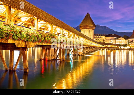Lucerne wooden Chapel Bridge and tower colorful evening view, town in central Switzerland Stock Photo