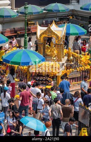 Many people pray respect the famous Erawan shrine at Ratchaprasong Junction in Bangkok capital city,Thailand. Stock Photo