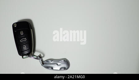 Remote control car key on the left with copy space. White background Stock Photo