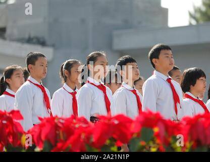 (190930) -- BEIJING, Sept. 30, 2019 (Xinhua) -- Members of the Chinese Young Pioneers pay tribute to deceased national heroes at a cemetery of martyrs in Lanzhou, capital of northwest China's Gansu Province, Sept. 30, 2019. Commemorative events were held all over the country to mark the country's Martyrs' Day, on the eve of National Day. (Xinhua/Du Zheyu) Stock Photo