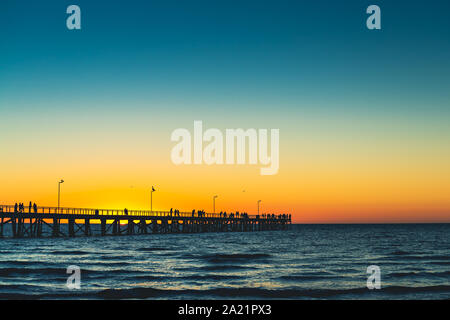 Semaphore Beach jetty with people enjoying spectacular sunset, South Australia Stock Photo