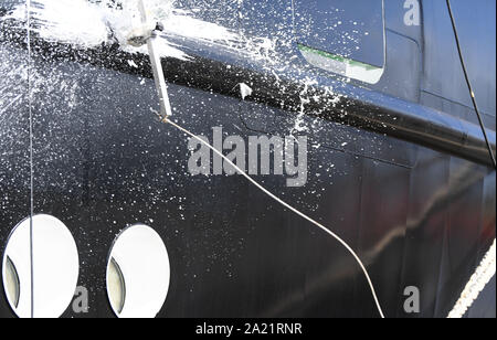 30 September 2019, Lower Saxony, Bern: A bottle of champagne shatters at the baptism of the surveying, wreck search and research vessel 'Atair', which was built for the Federal Maritime and Hydrographic Agency (BSH) at the Fassmer shipyard. With a length of 75 metres, the 114 million euro newbuilding is the largest BSH ship to date. Photo: Carmen Jaspersen/dpa Stock Photo