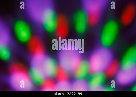 Colorful blurred bokeh with night light. Abstract festive background, pattern. Defocused illuminated dark backdrop. Lights disco backgrounds. Stock Photo