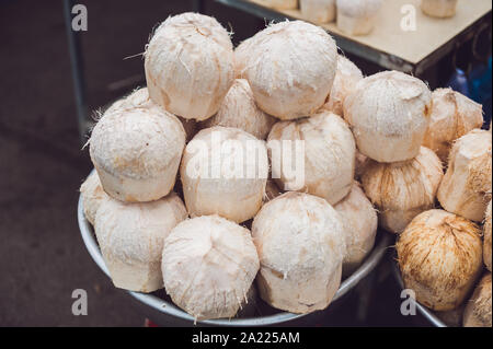 Coconuts in the Vietnamese market, typical street food business in Asia Stock Photo