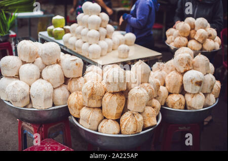 Coconuts in the Vietnamese market, typical street food business in Asia Stock Photo