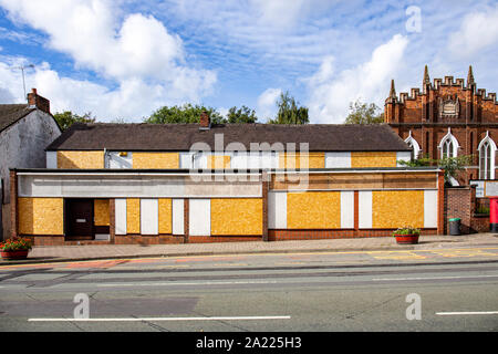 Closed down and boarded up office building in Crewe Cheshire UK Stock Photo