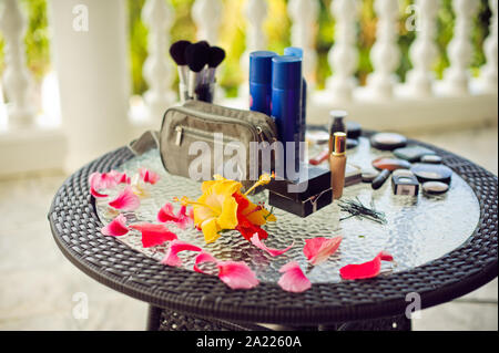 Spa, wellness setting with fresh flowers on a palm leaf background Stock Photo