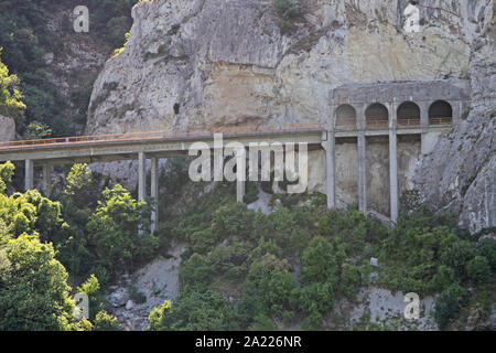 The Route 34 highway bridge and tunnel with arches running over side of mountain from the border between Romania and Serbia in Dobra, Serbia. Stock Photo