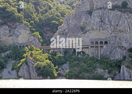 The Route 34 highway bridge and tunnel with arches running over side of mountain from the border between Romania and Serbia in Dobra, Serbia. Stock Photo