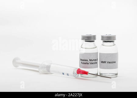 Medical concept showing medical 2 medical vials reading MMR Vaccine and Measles, Mumps & Rubella Vaccine with a syringe Stock Photo