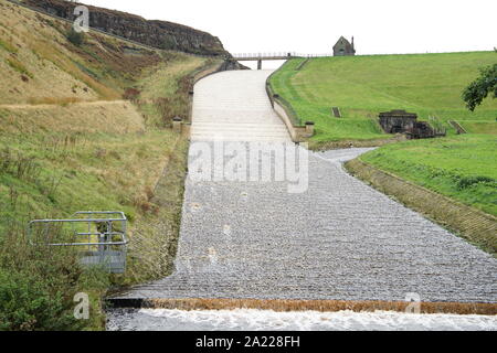 Butterley Dam Spillway in the Wesenden valley high in the pennines running with water after heavy rain in Marsden Huddersfield Yorkshire England Stock Photo