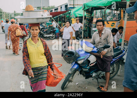 Woman carry weight on the head. Street vendor female with bowl on the head. Stock Photo