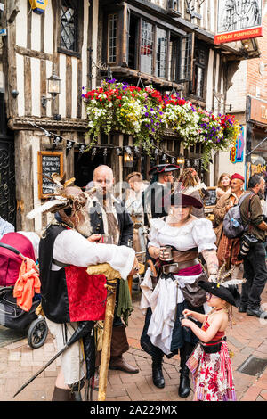 People dressed up as pirates gathering outside the Ye Olde Pumphouse timber framed pub in the old town during the Pirate Day festival in Hastings. Stock Photo