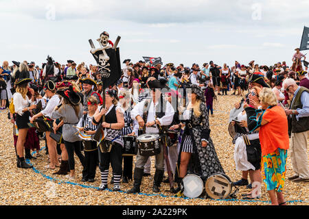 Pirate Day in Hastings, UK. Thousands of people dressed as pirates crowded into designated sectors on the beach for the world record attempt. Stock Photo
