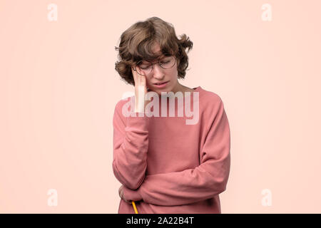 Sad mature woman ijn funny glasses looking down and cthinking about her life problems. Studio shot Stock Photo
