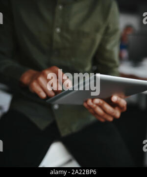 Close-up of a businessman folding and touching the digital tablet Stock Photo