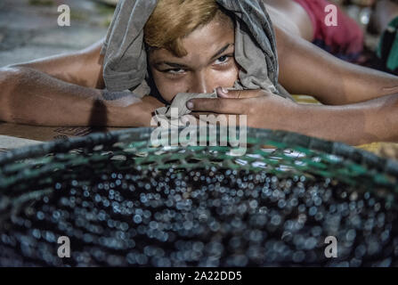 Boy laying on the streets selling acai berries Stock Photo