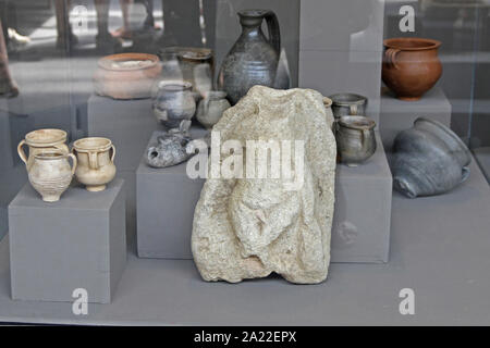 Ancient rock artifact, ceramic clay jars, jugs and pots on display in glass case at the National Archaeological Museum Djerdap, Kladovo, Serbia. Stock Photo