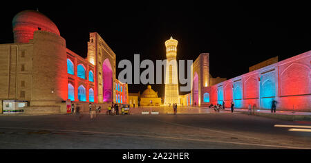 colorful illuminated ensemble of Mir-i Arab-Madressa Kalyan-Mosque and minaret, Bukhara, Uzbekistan, Central Asia Stock Photo