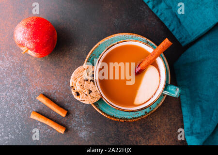 Wintertime chai-spiced apple cider with assam tea, cinnamon, ginger, cardamom and almond milk. Christmas or Thanksgiving cozy flat lay. Stock Photo