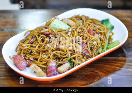 stir-fried noodles with pork, sausage and vegetable in Chinese style Stock Photo