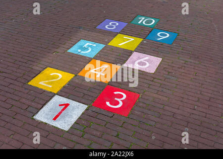 Colourful Hopscotch Playground Markings Numbers at Pavement Stock Photo