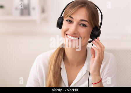 Hotline And Custoner Support. Smiling Woman In Headset Talking With Client Working In Call Center Office. Stock Photo