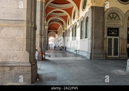 People walking under the elegant vaulted ceiling near the main  entrance to Porta Nuova  a major railway station in Turin ,Italy Stock Photo