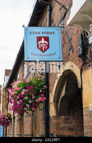 Name board on wall above the entrance to the Eton Porny Church of England First School in the High Street, Eton, Berkshire, England, UK Stock Photo