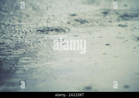 rain drops falling on a street Stock Photo