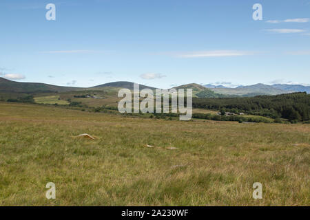 View of Ulpha and surrounding Lake District from Corney Fell, Corney, Cumbria UK - Summer's day, blue sky with light cloud, green fields Stock Photo