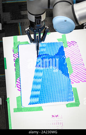 Robotic arm creating a portrait on paper from a digital file Stock Photo