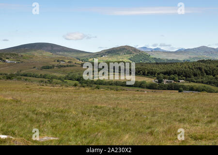 View of Ulpha and surrounding Lake District from Corney Fell, Corney, Cumbria UK - Summer's day, blue sky with light cloud, green fields Stock Photo