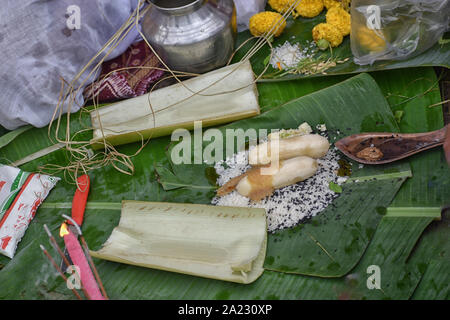 Soil malasa with rudraksha mala, Supari or betel nut, banana, pan pata or betel Leaf, banana Leaf, Red Thread (Kalava), agarbatti, flowers, sand decor Stock Photo