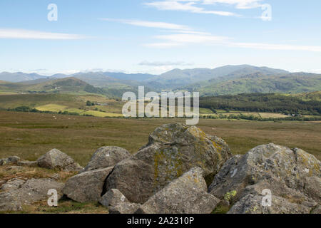 View of Ulpha and surrounding Lake District from Corney Fell, Corney, Cumbria UK - Summer's day, blue sky with light cloud, green fields Stock Photo