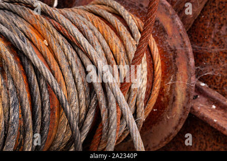 Old rusty cable drum and steel cable at Charlestown, Cornwall Stock Photo
