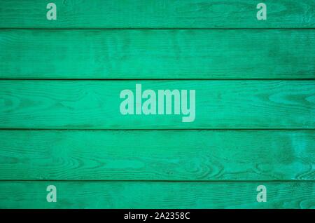 Wooden background texture. Creatively painted intense green boards. Stock Photo