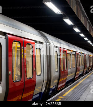 Train on the platform at Euston Square Underground Station, London UK, showing reflection of train on ceiling above. Stock Photo