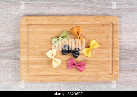 Italian pasta colored with natural dyes on the wooden table Stock Photo