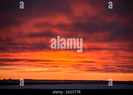 Sunset skies over Hudson Bay at freeze-up, Cape Churchill, Manitoba, Canada Stock Photo