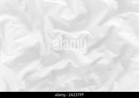 white crumpled bed sheet closeup top view Stock Photo