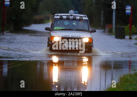 A Land Rover drives through a flooded section of Barnsdale Road between Allerton Bywater & Castleford Stock Photo