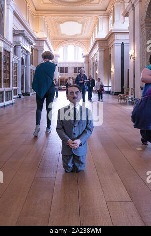 Maurizio Cattelan's kneeling Hitler Boy art exhibit in Blenheim Palace. It was here that famous his 18 carot Golden toilet art exhibit was stolen. Stock Photo